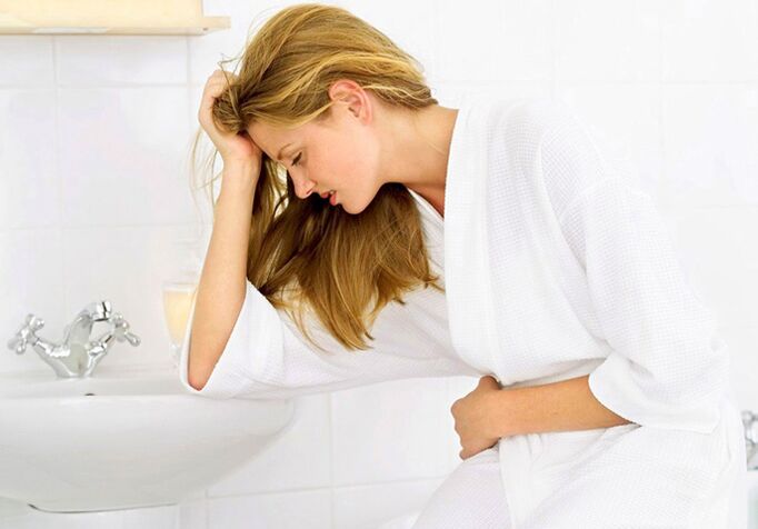 A woman is worried about symptoms of cystitis in the form of frequent and painful urination